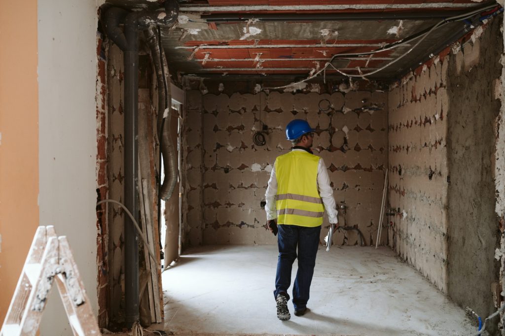 foreman or unrecognizable architect working on blueprints on construction site. Home improvement